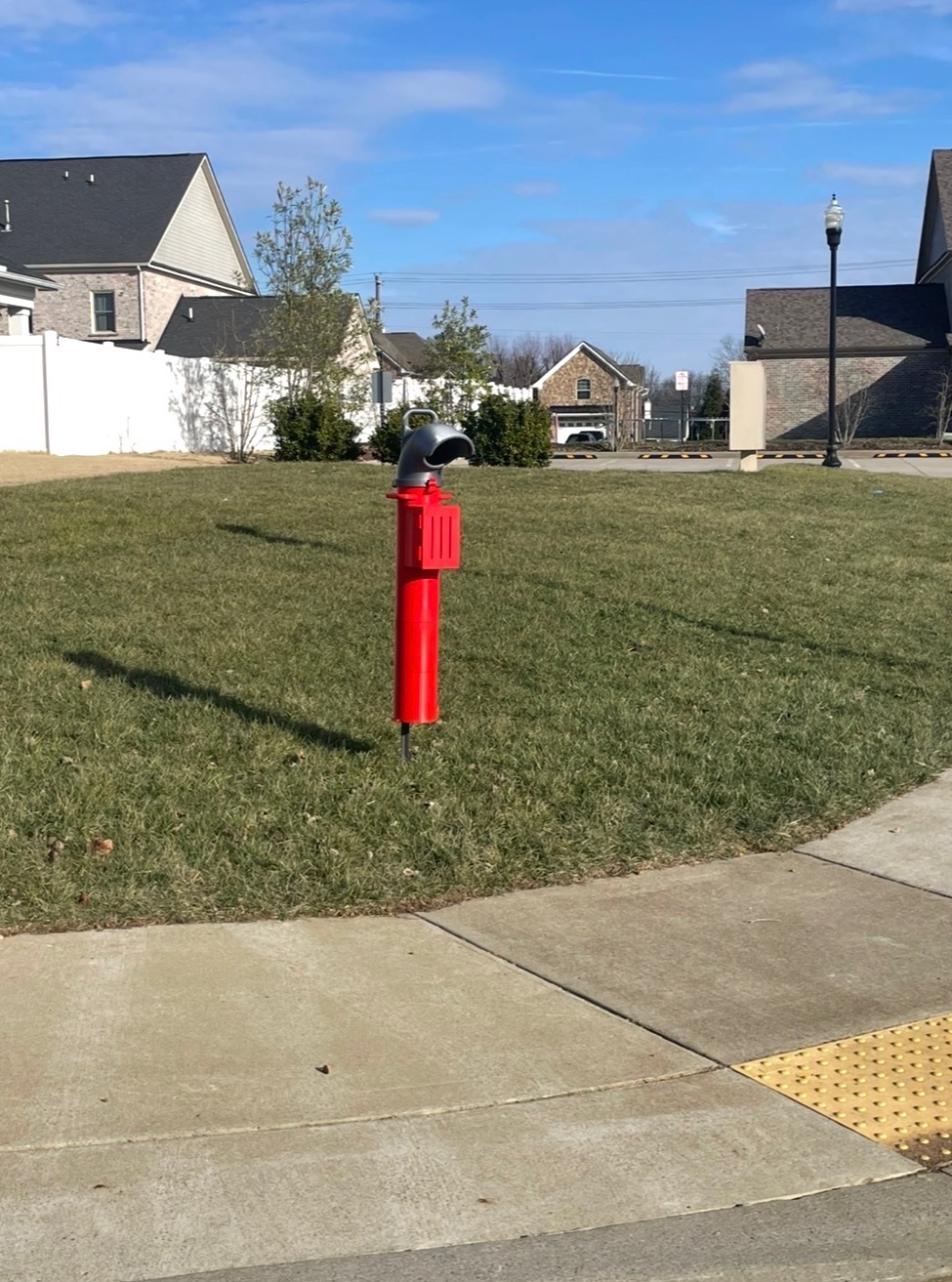 A red Scout Station on an HOA common lawn
